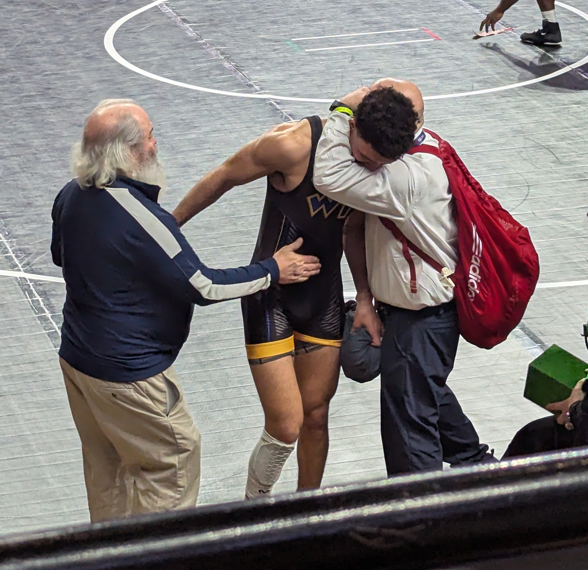 Nurrideen Ahmad-Statts is congratulated by assistant coach Joe Silvestri and head coach Ron Frank after earning All-American status and the 2025 NCWA National championships